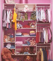Pink wardrobe full of clothes and toys